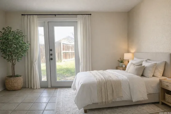 a bedroom with a bed and a potted plant