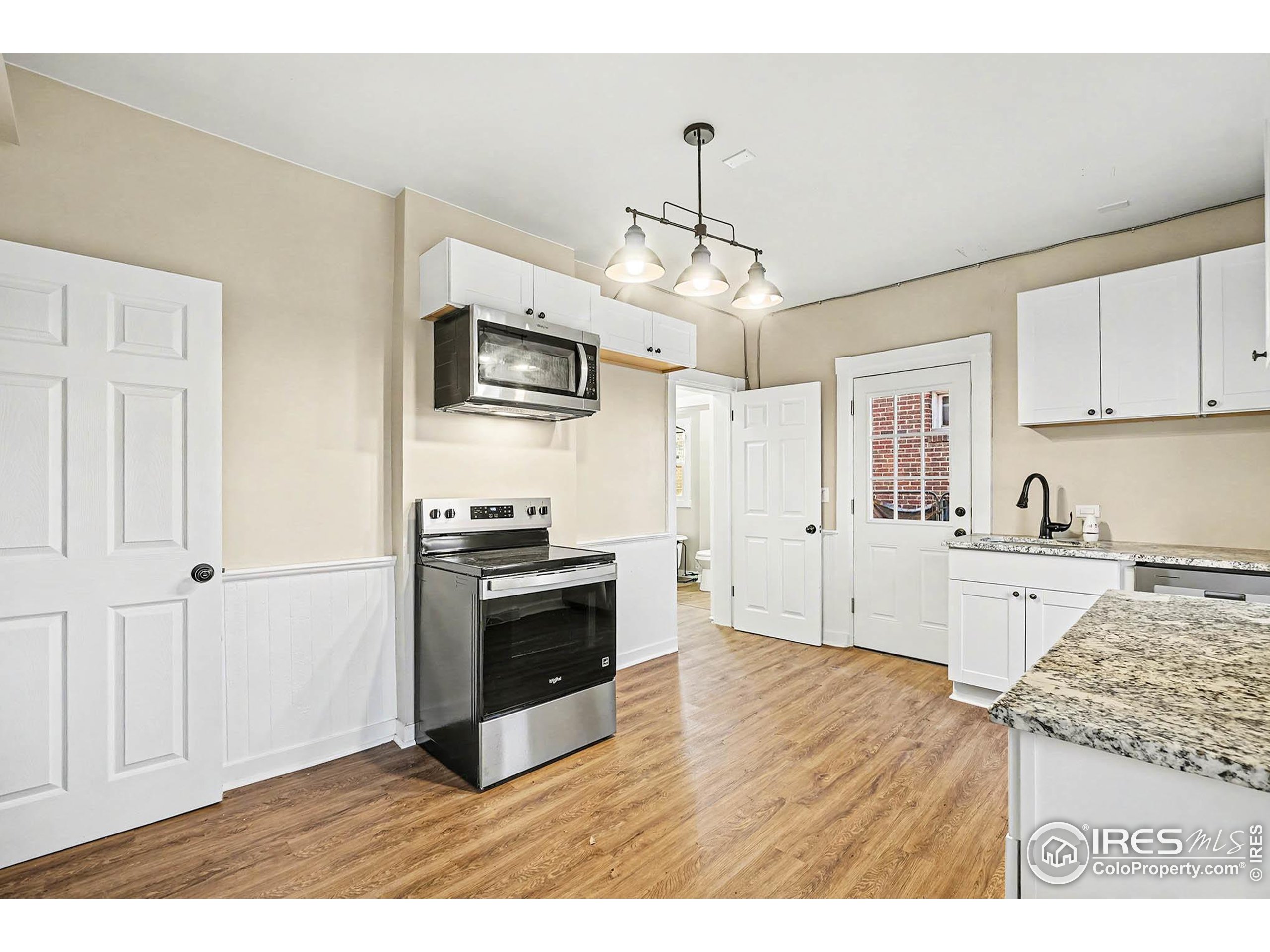 1330 8th Street Greeley, CO 80631 - Photo 14 of 27 a kitchen with stainless steel appliances granite countertop a stove and refrigerator