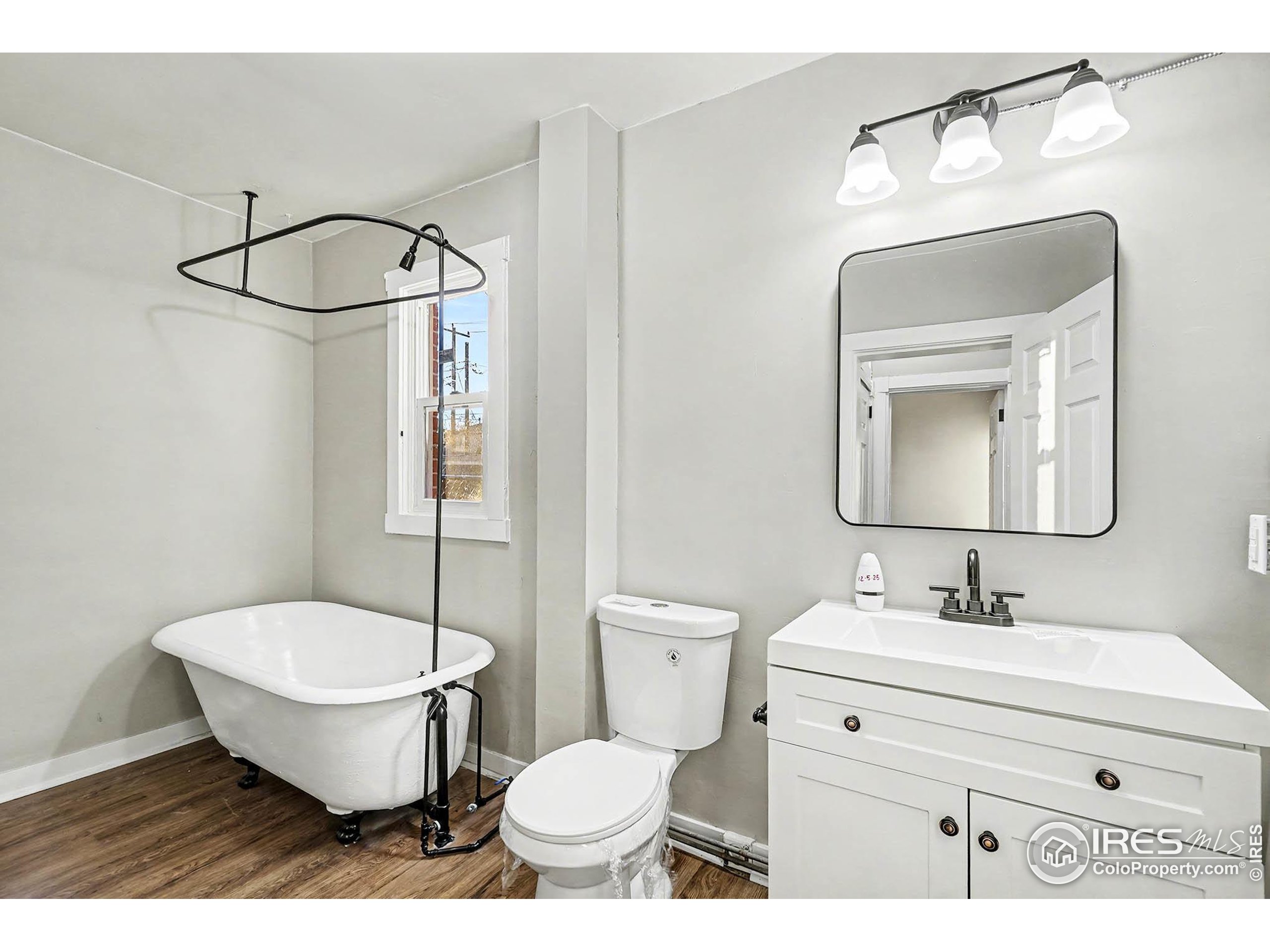 1330 8th Street Greeley, CO 80631 - Photo 15 of 27 a bathroom with a toilet sink and mirror