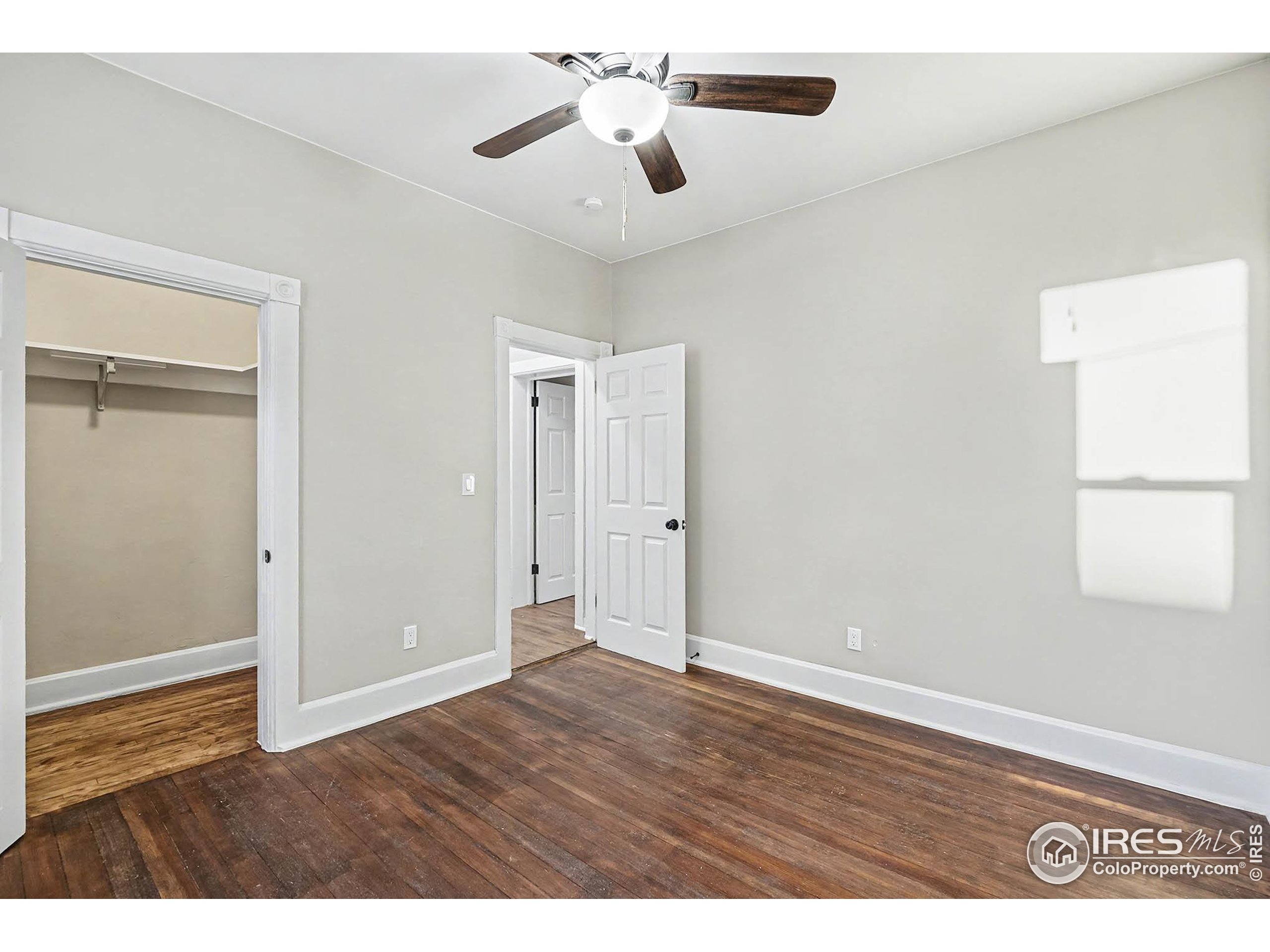 1330 8th Street Greeley, CO 80631 - Photo 19 of 27 a view of an empty room with window and wooden floor