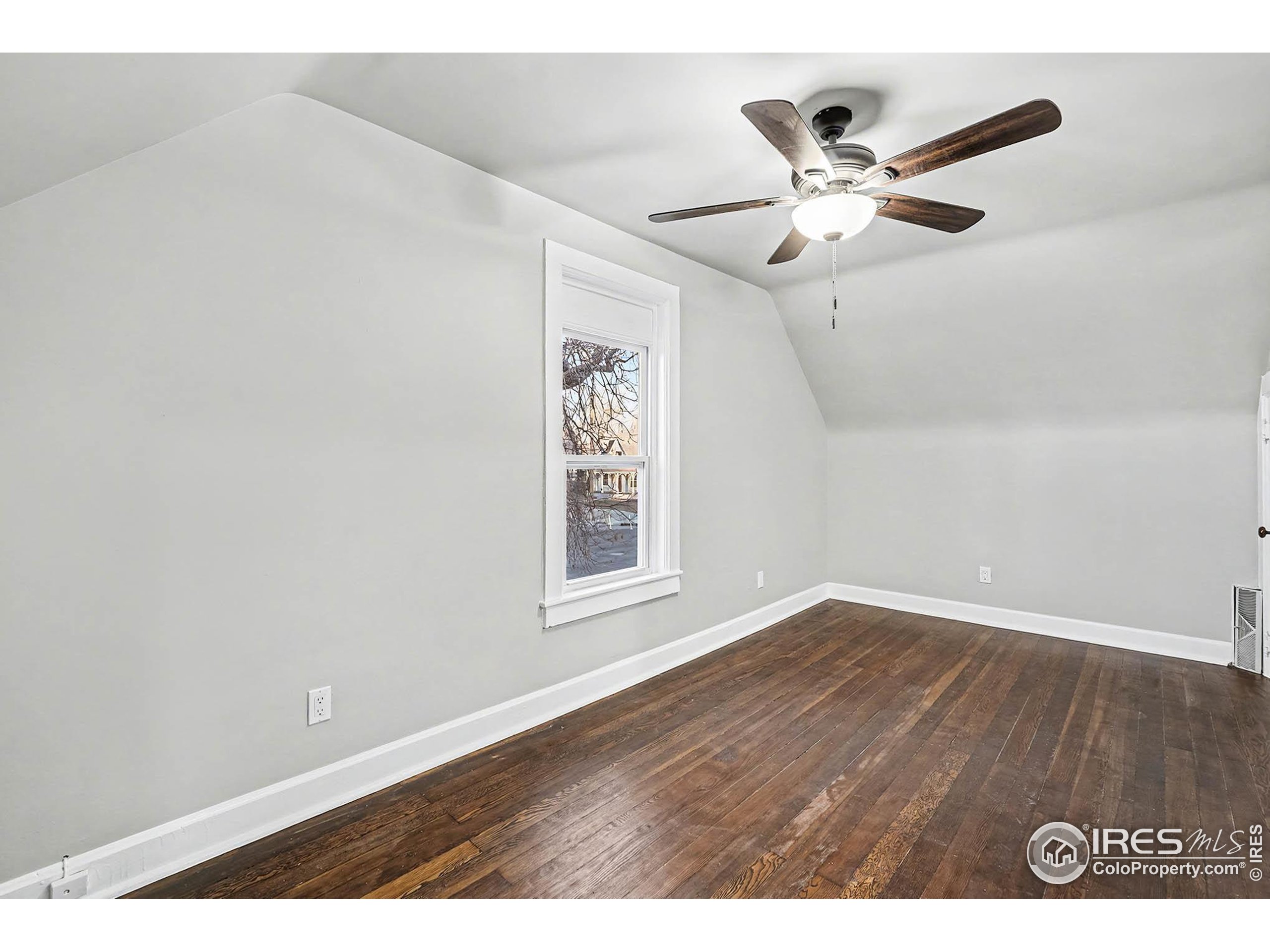1330 8th Street Greeley, CO 80631 - Photo 22 of 27 a view of an empty room with wooden floor and a window