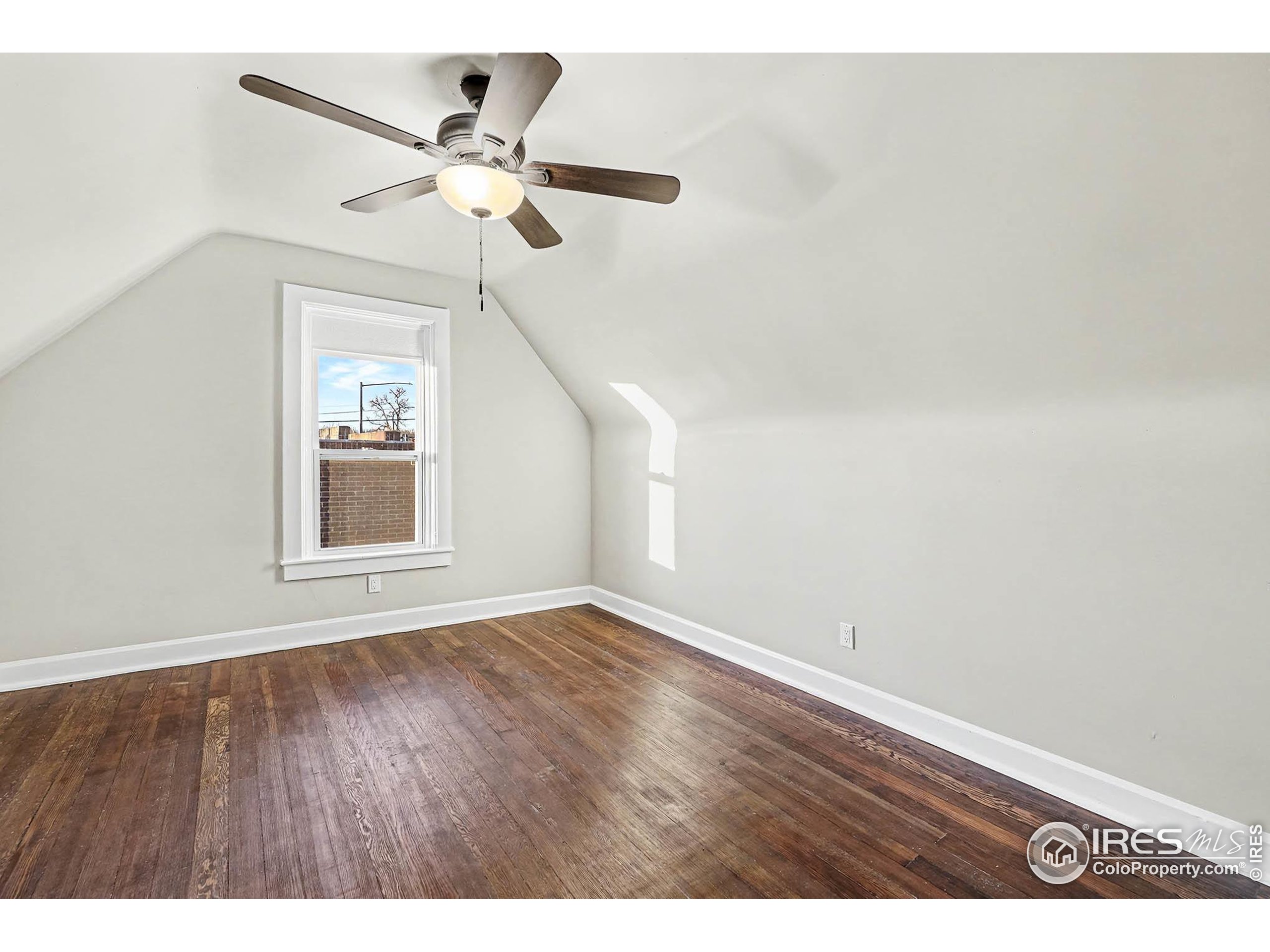 1330 8th Street Greeley, CO 80631 - Photo 23 of 27 a view of an empty room with wooden floor