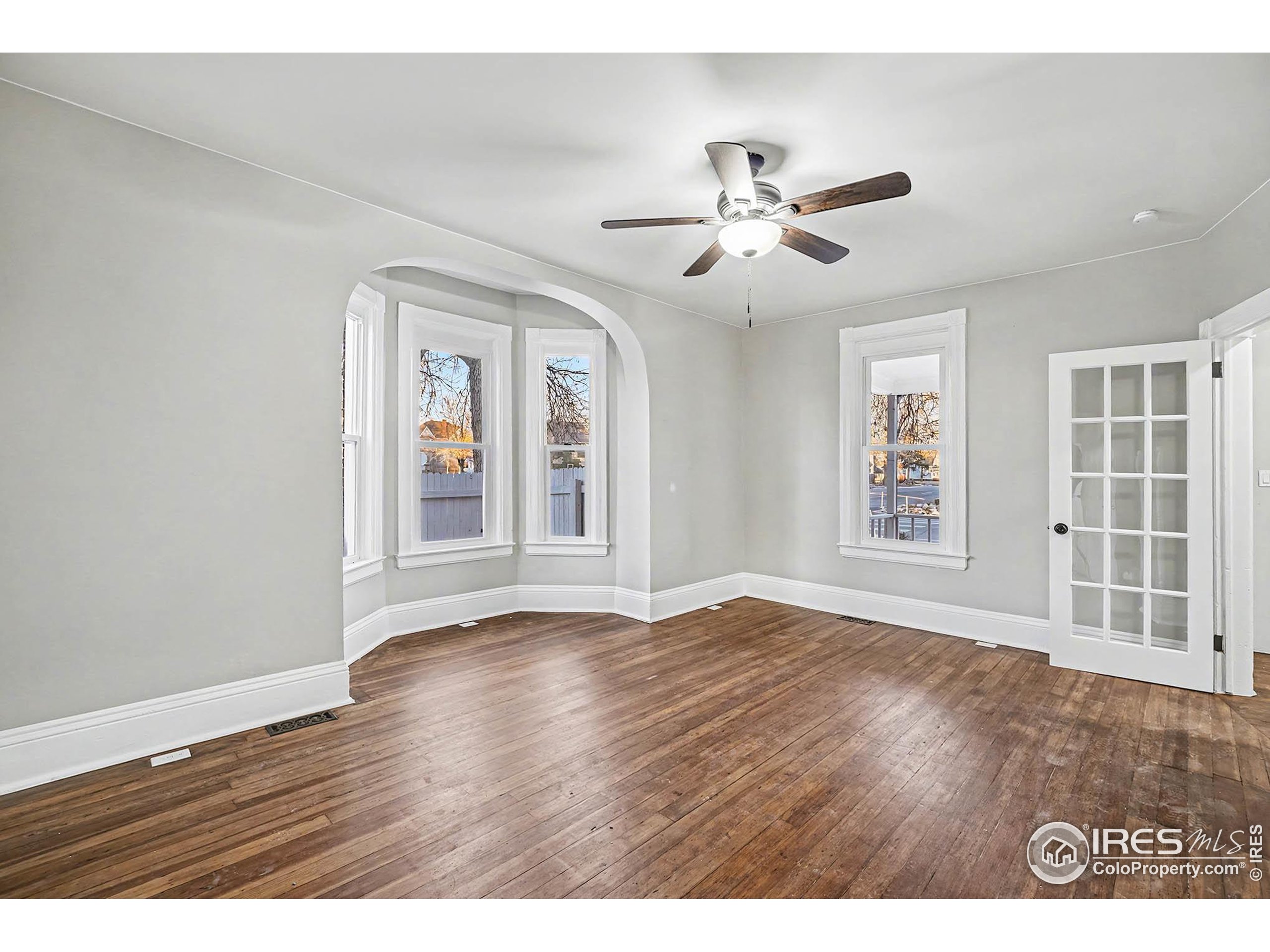 1330 8th Street Greeley, CO 80631 - Photo 9 of 27 a view of an empty room with wooden floor and a window
