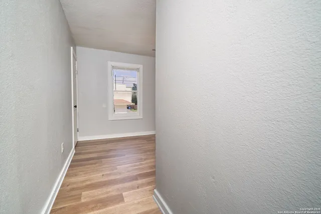 a view of a room with wooden floor
