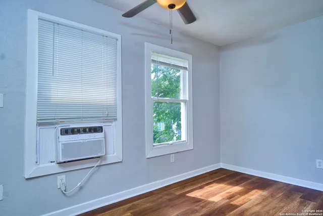 a view of a bathroom with a tub mirror and window