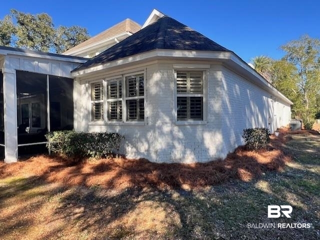404 Peninsula Boulevard Gulf Shores, AL 36542 - Photo 36 of 51 View of side of home with a sunroom and brick siding