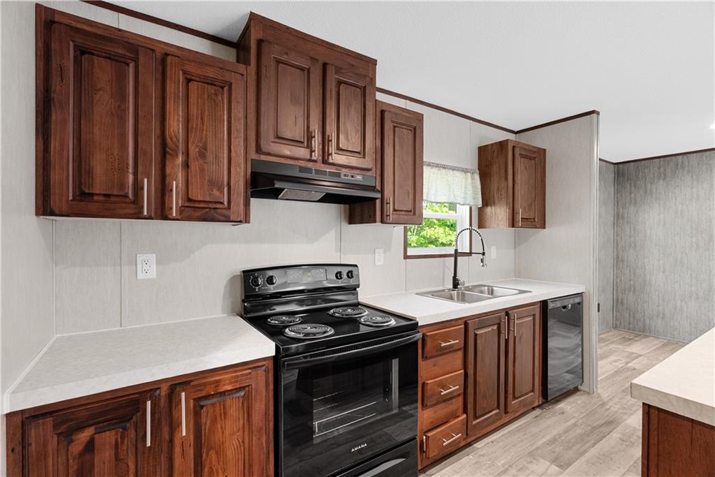 120 James Street Northwest Resaca, GA 30735 - Photo 12 of 31 a kitchen with stainless steel appliances granite countertop a stove a sink and a microwave