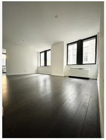 a view of an empty room with glass door