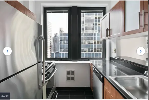 a view of a kitchen with a sink and large window