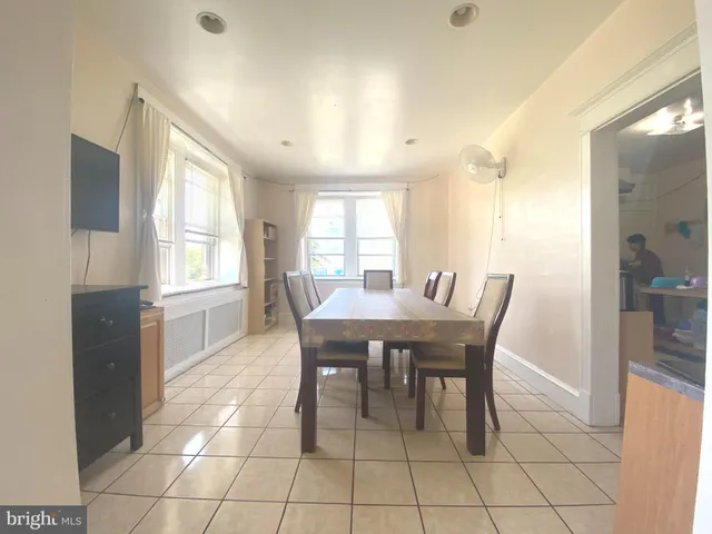 a kitchen with stainless steel appliances a sink a window and white cabinets