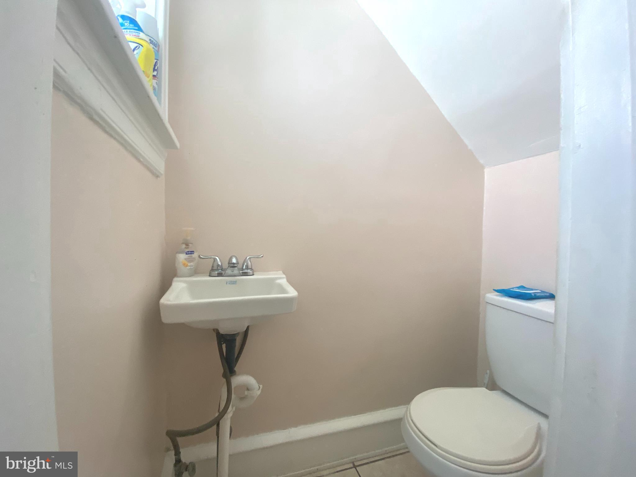 2249 Knorr Street Philadelphia, PA 19149 - Photo 21 of 40 a bathroom with a sink a toilet and a mirror