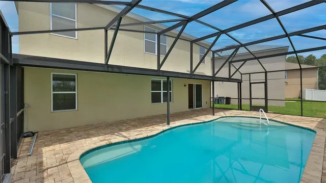 a view of a backyard with a swimming pool
