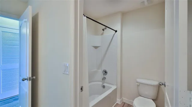 a bathroom with a toilet and a shower