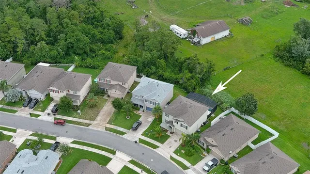 an aerial view of a house with outdoor space and lake view