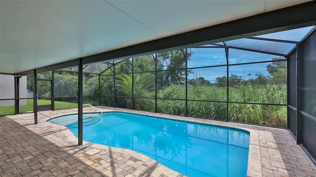 an aerial view of a house with a yard and potted plants