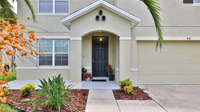a view of house with swimming pool outdoor seating