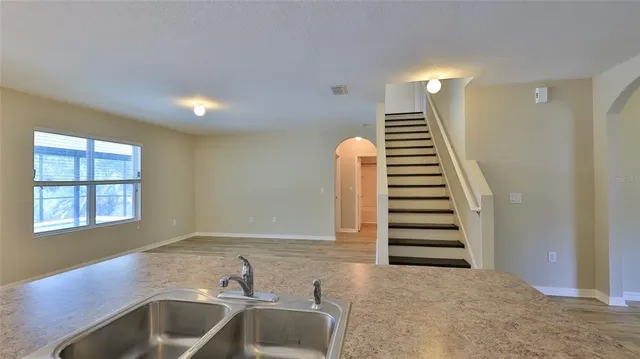 a view of a kitchen with sink and natural light