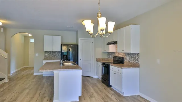 a kitchen with a chandelier