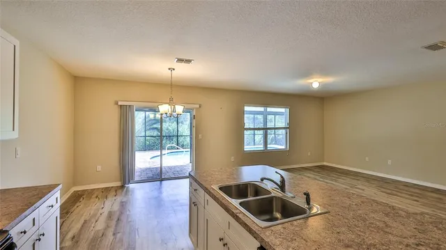 a kitchen that has a sink cabinets counter space and a window