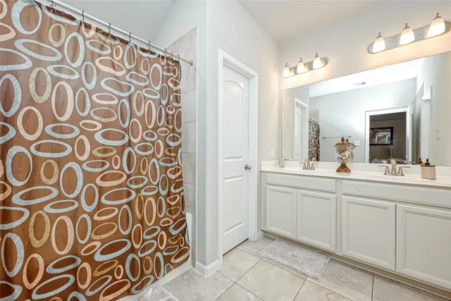 a spacious bathroom with a sink and a mirror