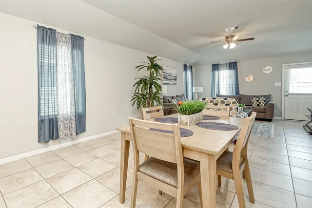 a dining room with furniture and window
