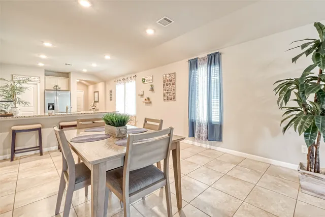 a view of a dining room with furniture and a potted plant