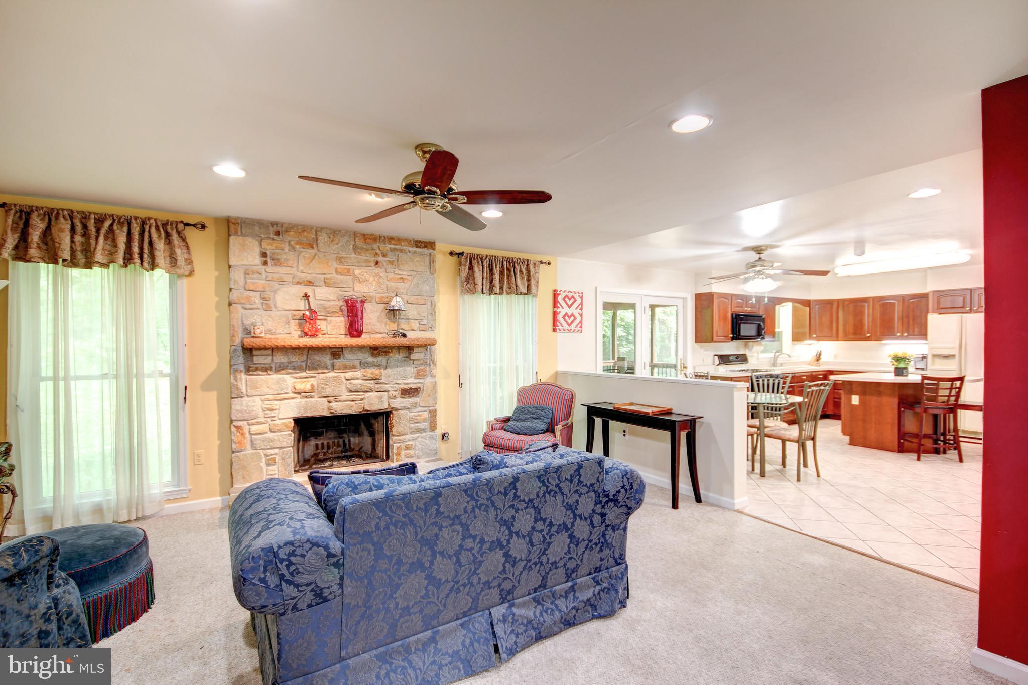 12412 Ivy Mill Road Reisterstown, MD 21136 - Photo 5 of 44 Living room with stone fireplace open to kitchen