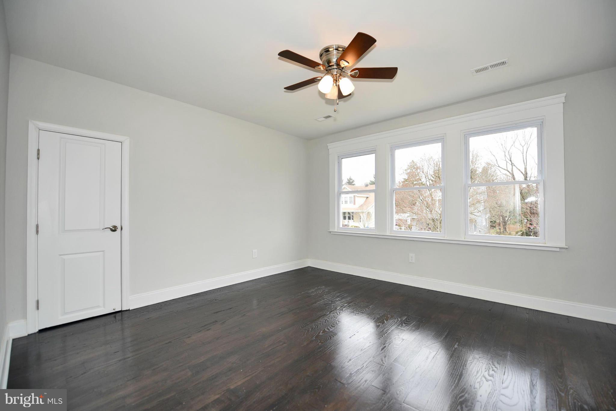 809 Cedarcroft Road Baltimore, MD 21212 - Photo 20 of 26 a view of a room with wooden floor and windows