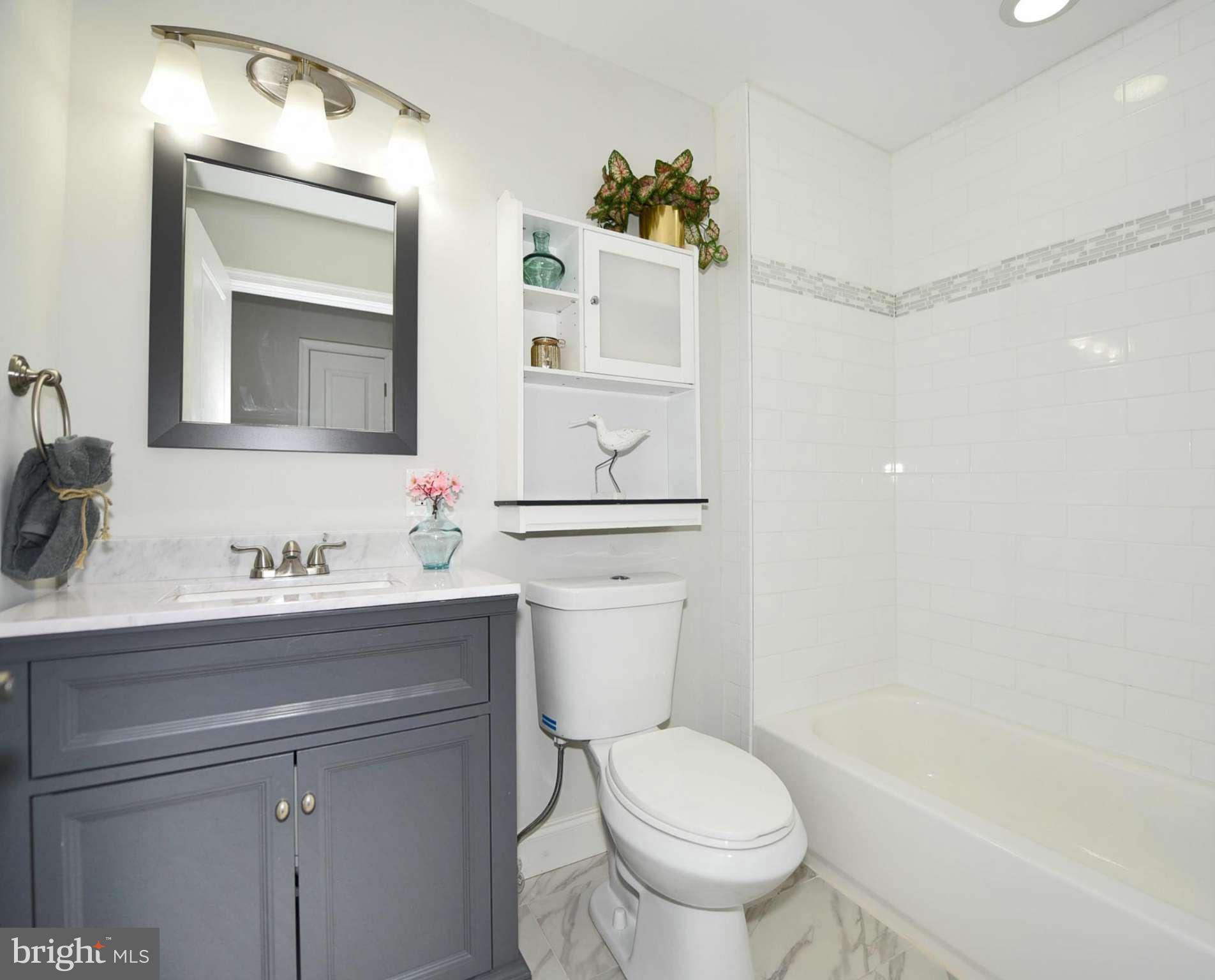 809 Cedarcroft Road Baltimore, MD 21212 - Photo 22 of 26 a bathroom with a sink a toilet and mirror