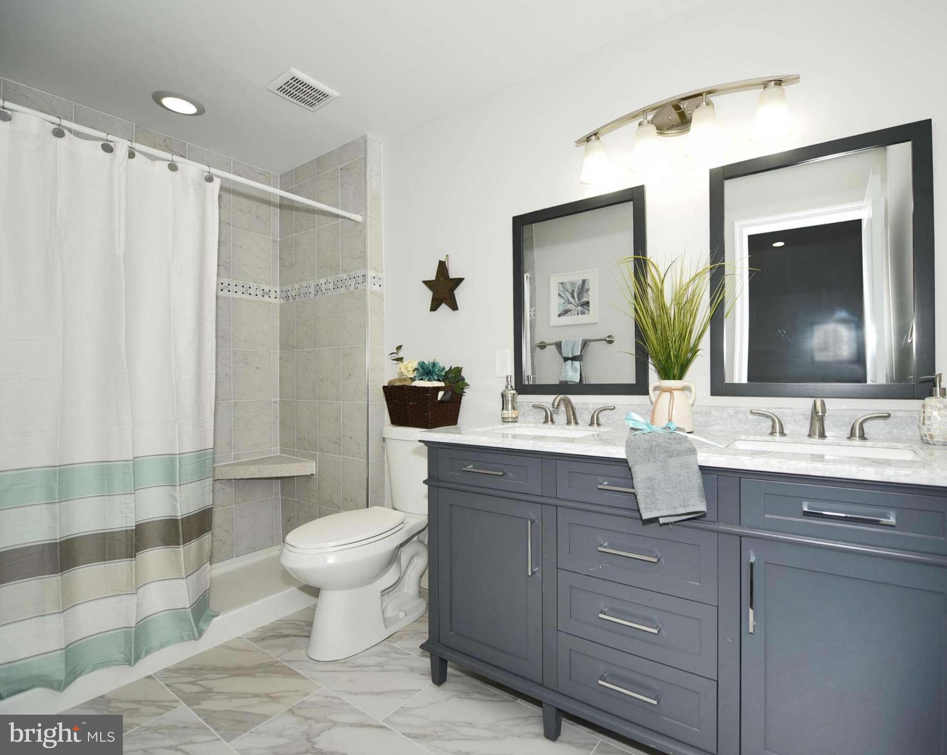 809 Cedarcroft Road Baltimore, MD 21212 - Photo 23 of 26 a bathroom with a double vanity sink mirror and toilet
