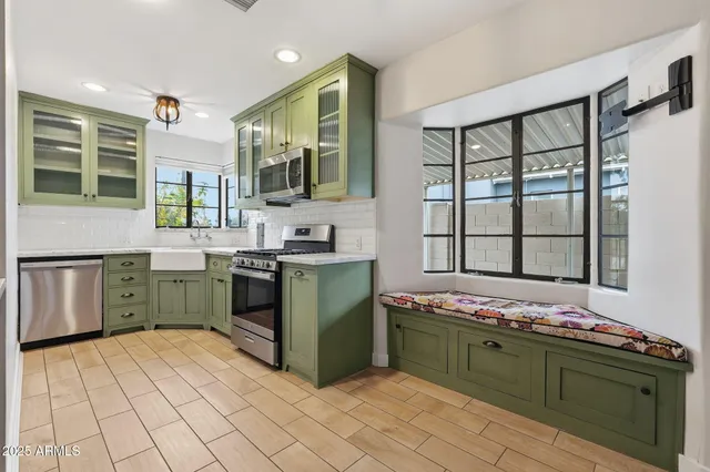 a view of a kitchen with fridge and wooden floor