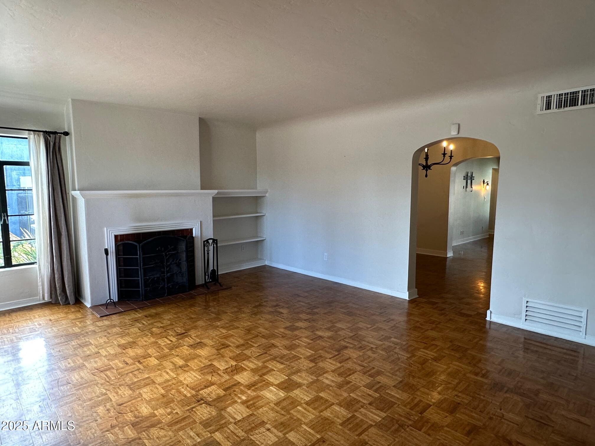 1315 West Holly Street Phoenix, AZ 85007 - Photo 2 of 24 an empty room with windows and fireplace