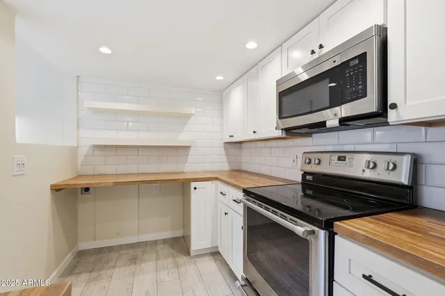 an empty room with a empty space and windows