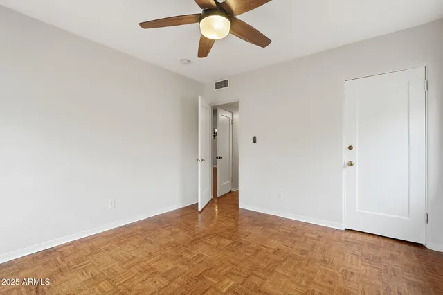 a view of a backyard with a tree front of house