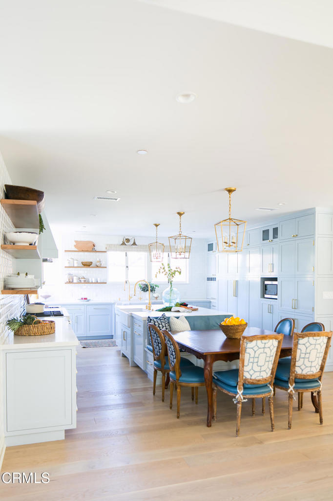 233 Hillside Road South Pasadena, CA 91030 - Photo 27 of 64 a kitchen with a dining table chairs and refrigerator