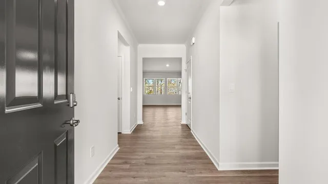 a view of a hallway with wooden floor