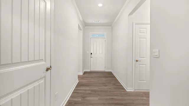 a view of a hallway with wooden floor