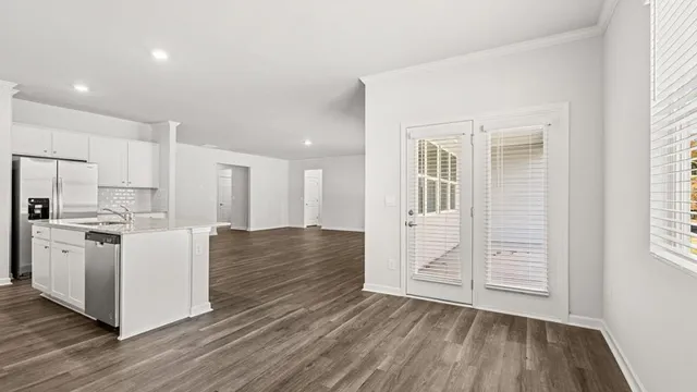 a view of a kitchen and wooden floor