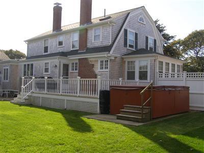 Undisclosed Address Harwich Port, MA 02646 - Photo 6 of 7 a front view of a house with a yard