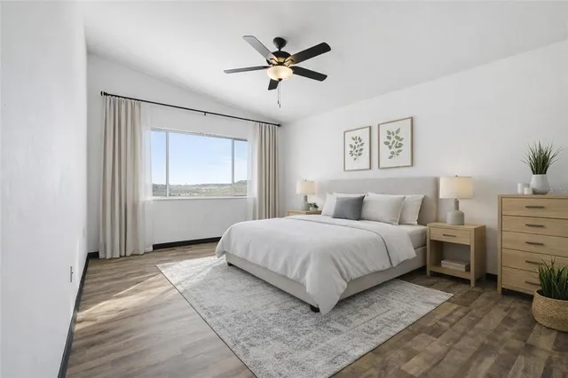 a spacious bedroom with a bed and a window