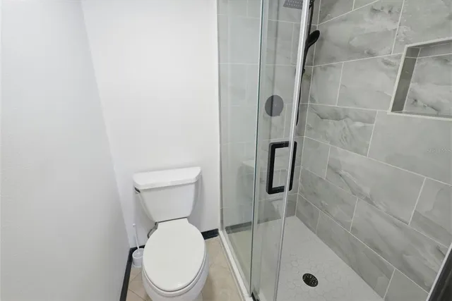 a bathroom with a toilet and shower