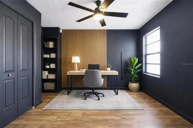 a workspace with furniture window and wooden floor