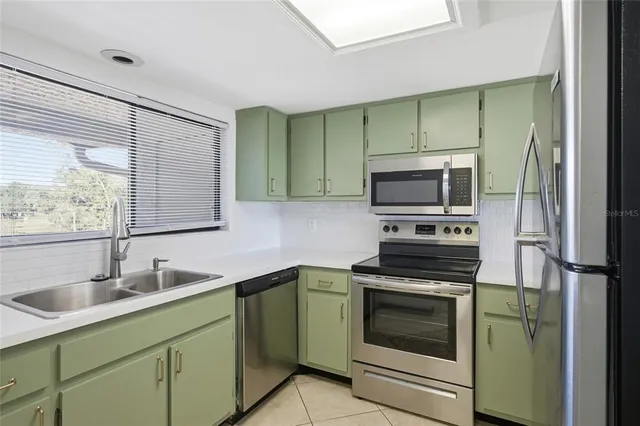 a kitchen with a sink stove and microwave