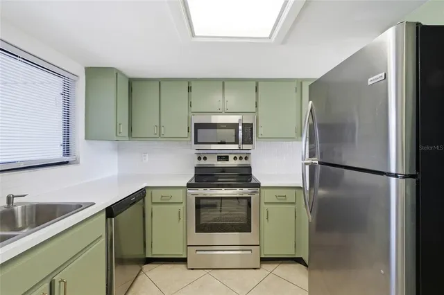 a kitchen with a stove sink and refrigerator