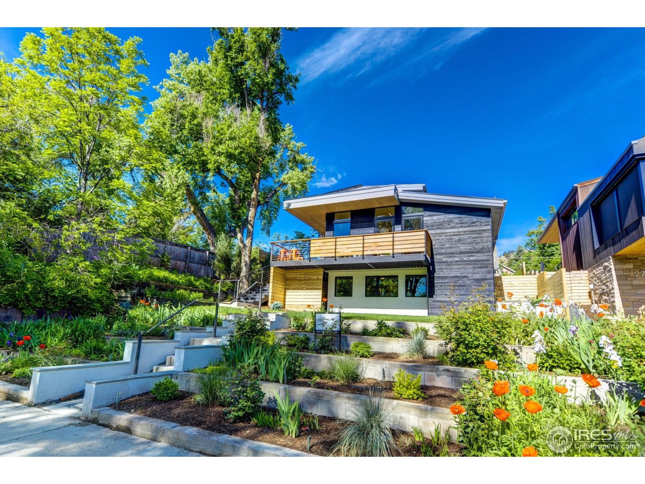 2725 6th Street Boulder, CO 80304 - Photo 1 of 40 a front view of a house with a yard