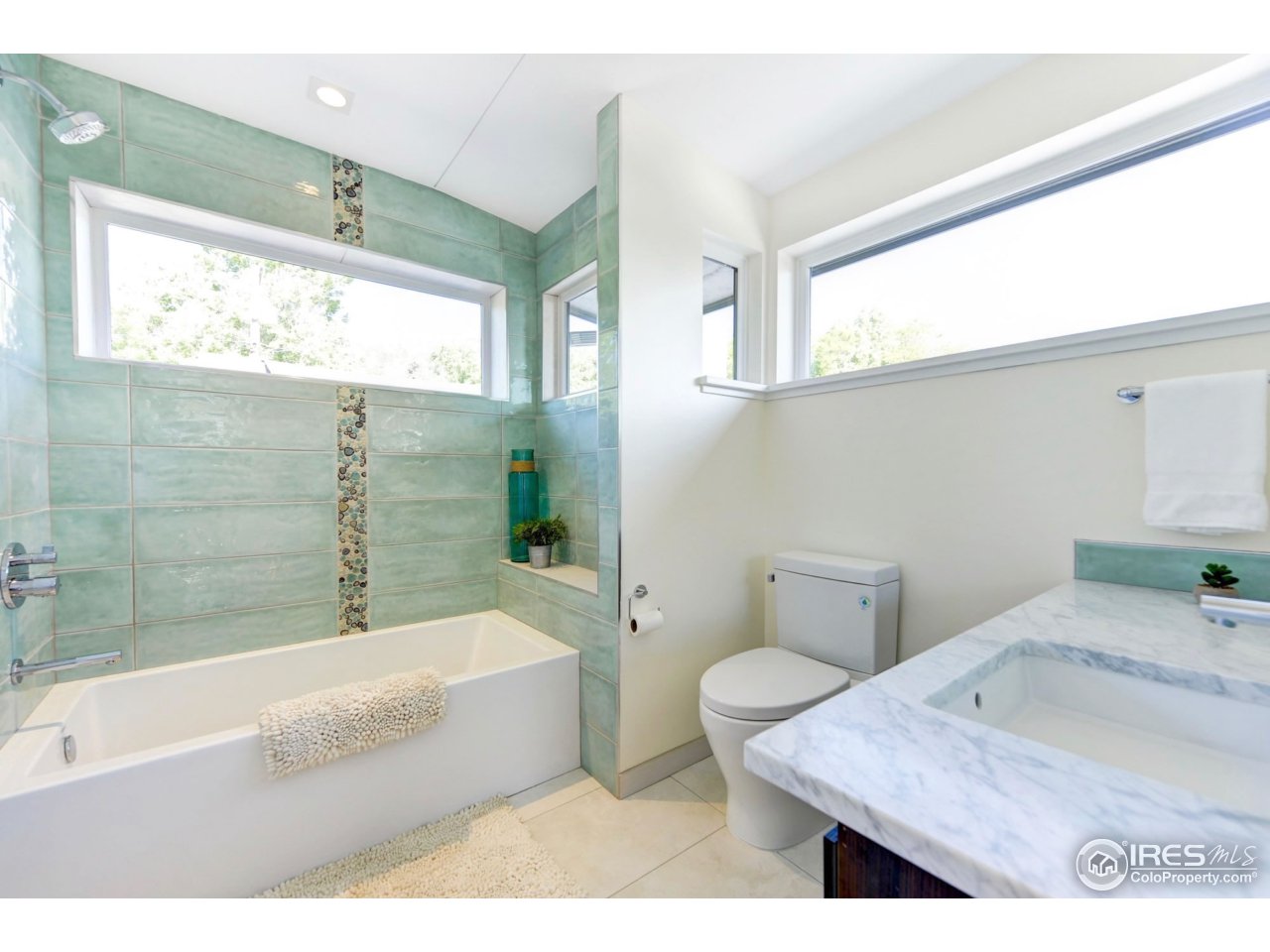 2725 6th Street Boulder, CO 80304 - Photo 22 of 40 a bathroom with a granite countertop sink a toilet a mirror and bathtub