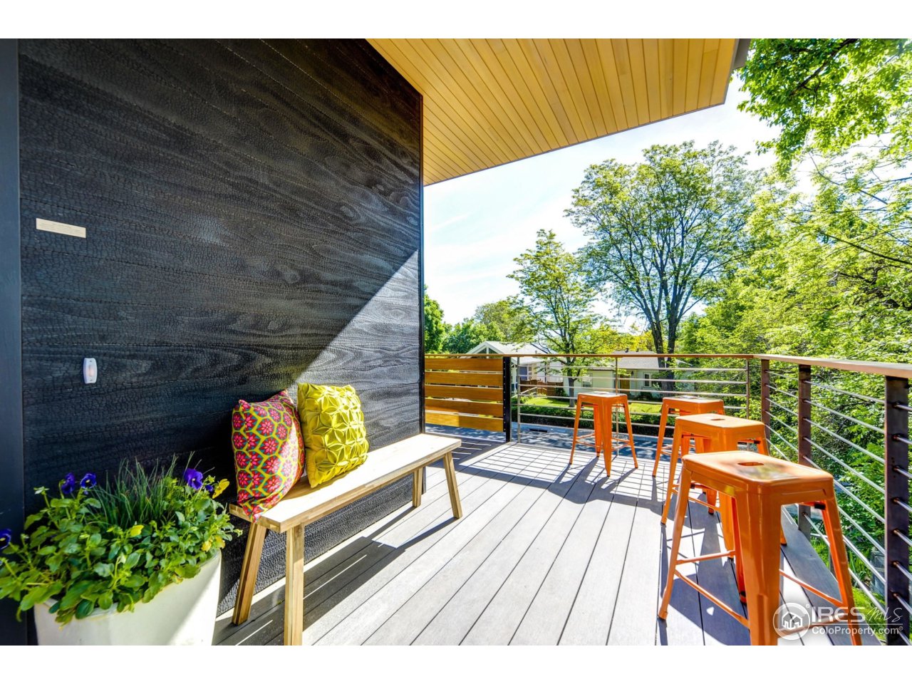2725 6th Street Boulder, CO 80304 - Photo 24 of 40 a balcony with wooden floor and outdoor seating