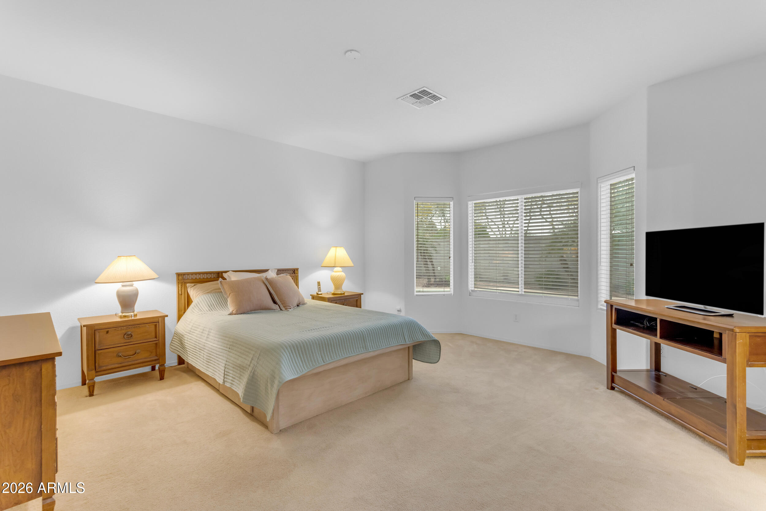 3724 East Derringer Way Gilbert, AZ 85297 - Photo 18 of 45 a bedroom with a bed and a flat screen tv
