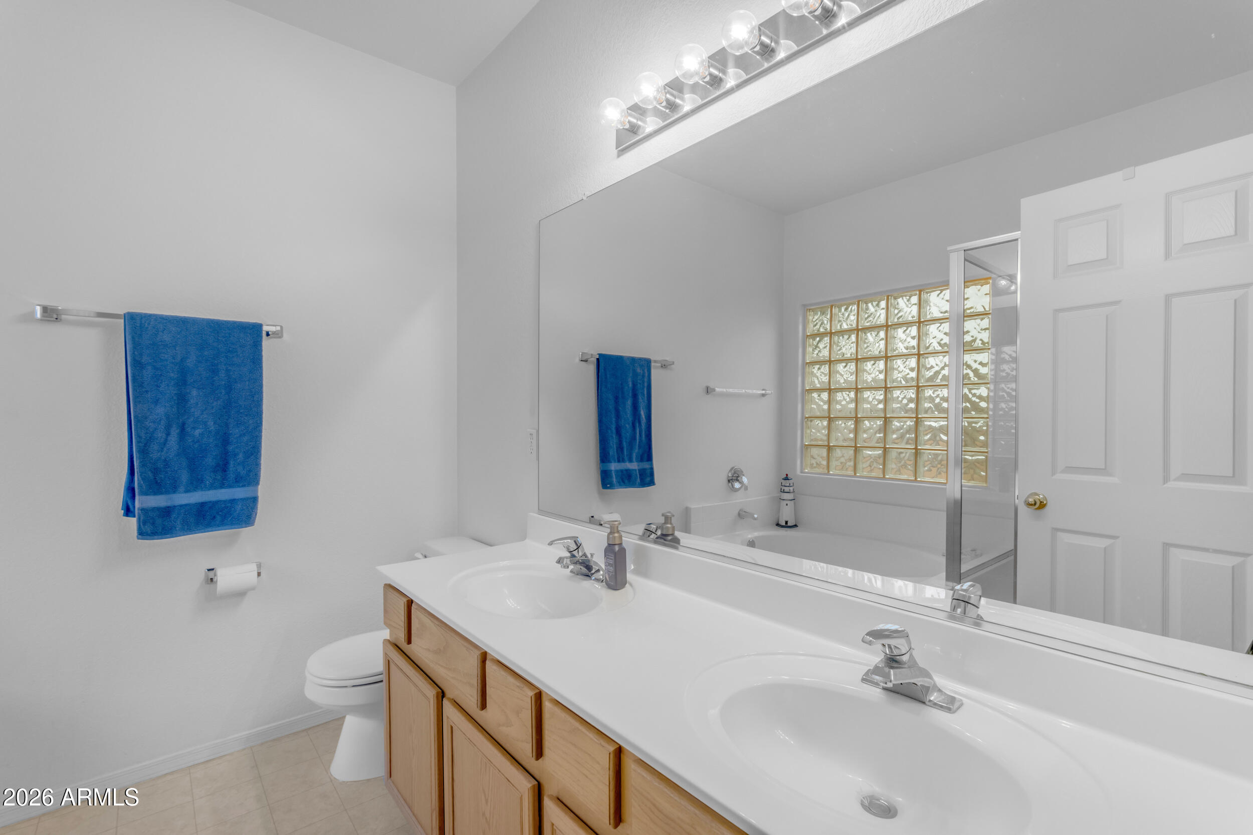 3724 East Derringer Way Gilbert, AZ 85297 - Photo 22 of 45 a bathroom with a double vanity sink toilet and a mirror