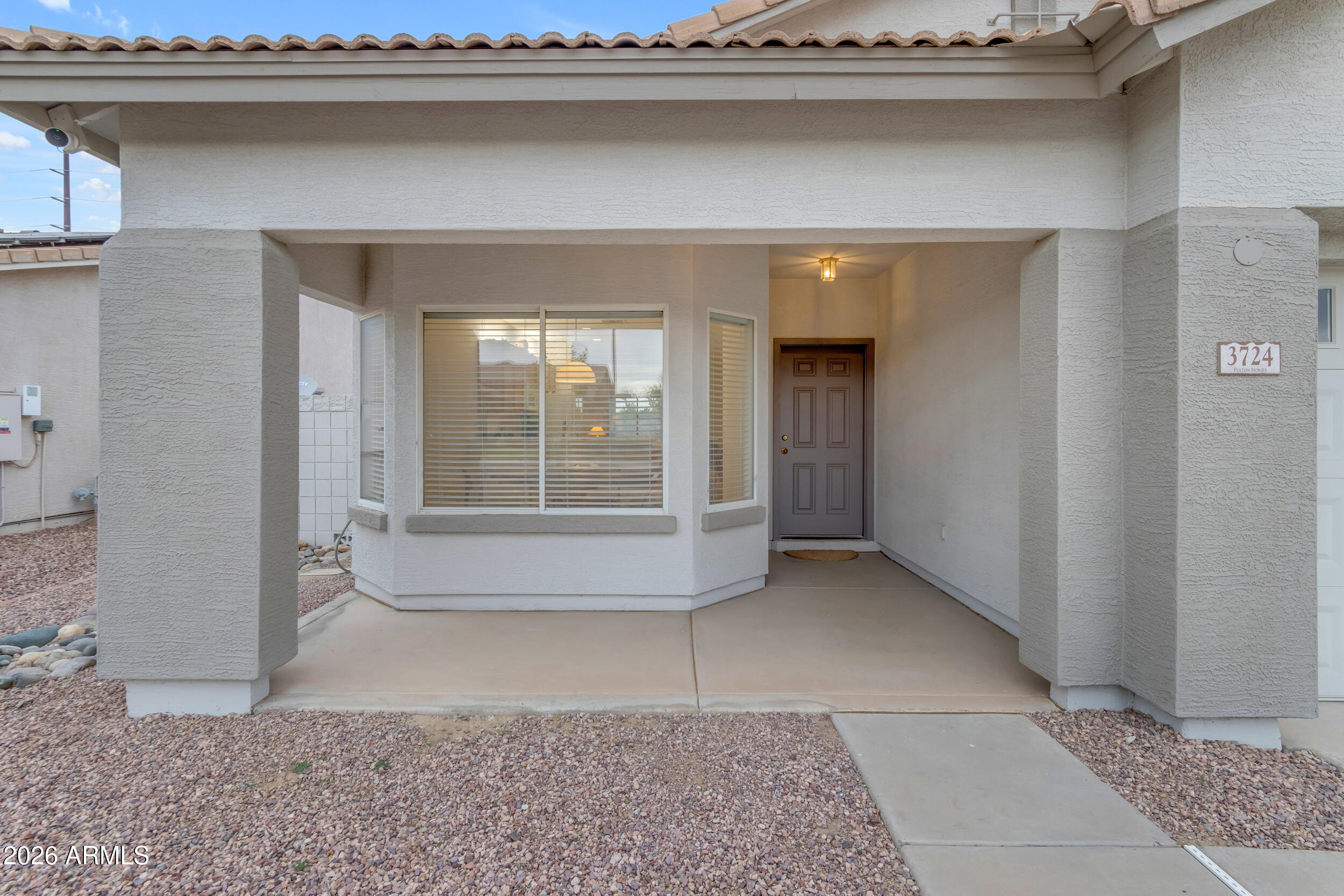 3724 East Derringer Way Gilbert, AZ 85297 - Photo 6 of 45 a view of an empty room with wooden floor and a window